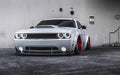 White dodge challenger with white headlight and fog light halos