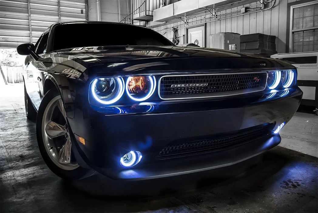 Front end of a Dodge Challenger with white LED headlight and fog light halos.