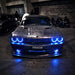 Front end of a Dodge Challenger with blue LED headlight and fog light halos.