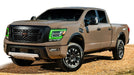 Brown Nissan Titan with green headlight DRLs.