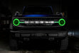 Front view of a blue Ford Bronco with green halos and DRLs.