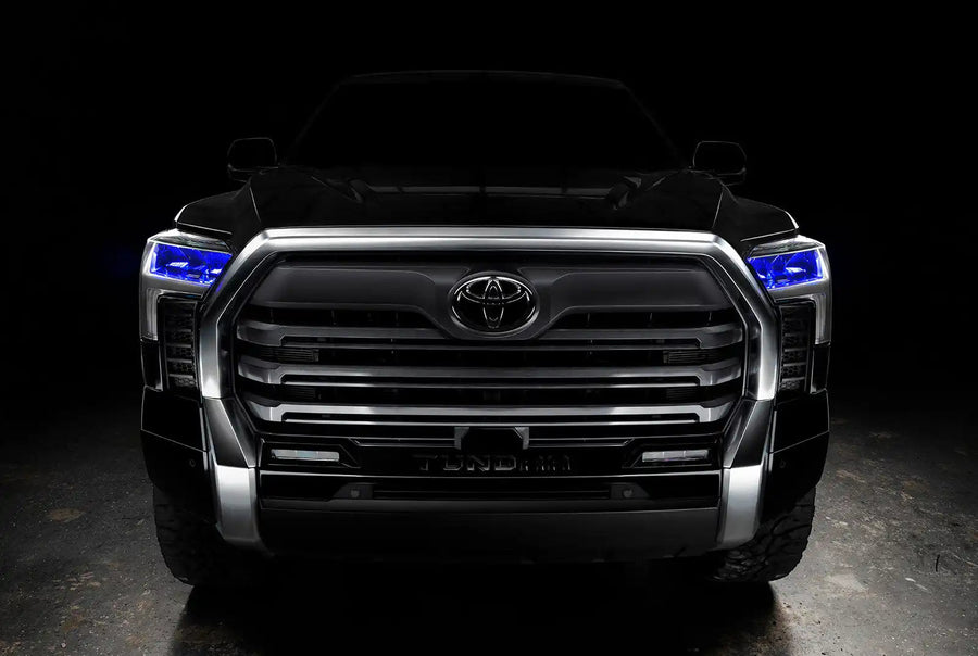  Straight front view of a black Toyota Tundra with blue demon eye projectors.