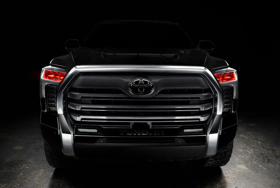  Straight front view of a black Toyota Tundra with red demon eye projectors.