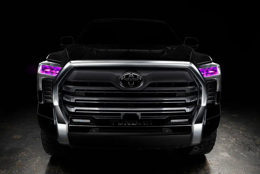  Straight front view of a black Toyota Tundra with pink demon eye projectors.