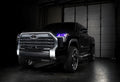 Three quarters view of a black Toyota Tundra with purple demon eye projectors.