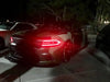 Three quarters view of a Dodge Charger with red headlight DRLs.