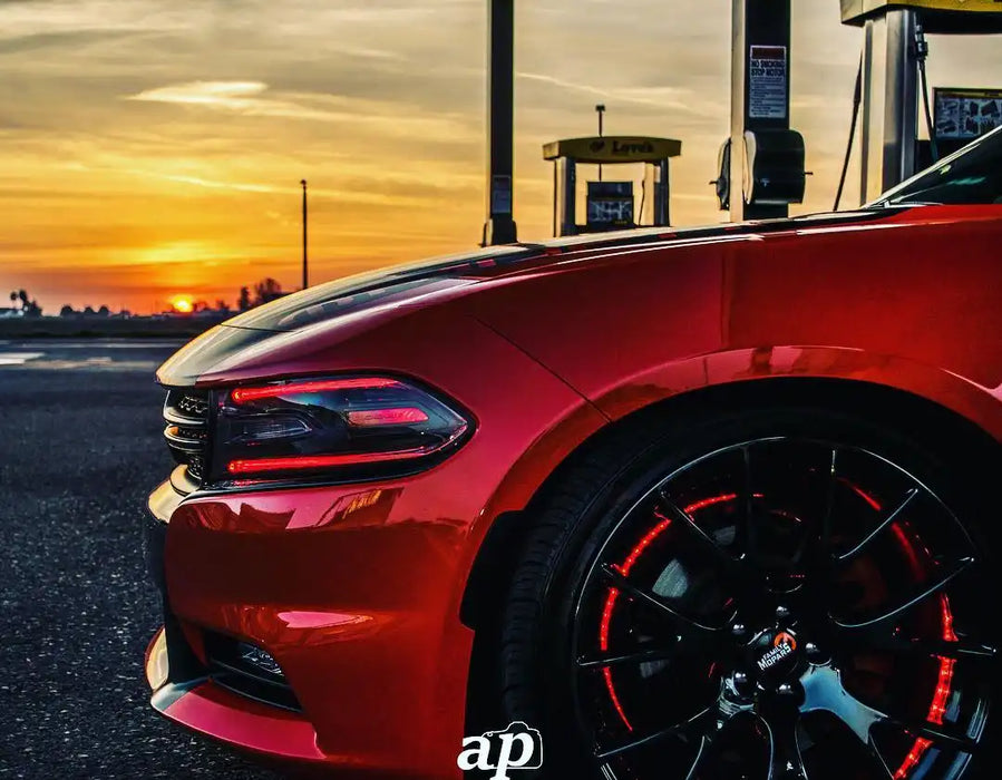 Side view of the front end of a Dodge Charger with red headlight DRLs.
