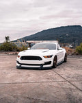 Three quarters view of a Ford Mustang with amber headlight halos and DRLs.