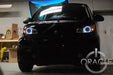 Smart Car with white LED headlight halo rings installed.
