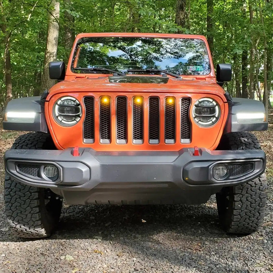 Front end of a Jeep Wrangler JL with amber Pre-Runner Style LED Grill Light Kit installed.