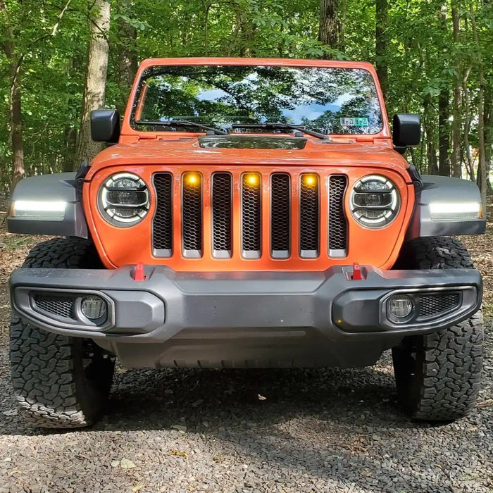 Front end of a Jeep Wrangler with amber LED Grill Light Kit installed.