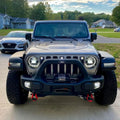 Front end of a Jeep Wrangler JL with white Pre-Runner Style LED Grill Light Kit installed.