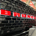 Extreme close-up on the front end of a Ford Bronco with Universal Illuminated LED Letter Badges installed.