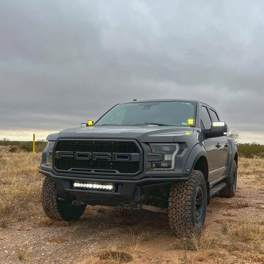 Three quarters view of a Ford Raptor with 2015-2020 Ford F-150 LED Off-Road Side Mirrors installed.