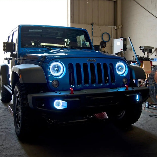 Three quarters view of a Jeep Wrangler with white LED headlight and fog light halos installed.