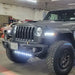 Jeep parked in a garage with multiple lighting products installed and turned on.