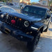 Front end of a Jeep Wrangler with amber LED Grill Light Kit installed.