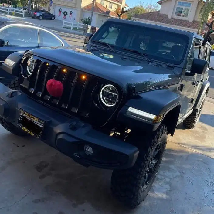Front end of a Jeep Wrangler JL with amber Pre-Runner Style LED Grill Light Kit installed.