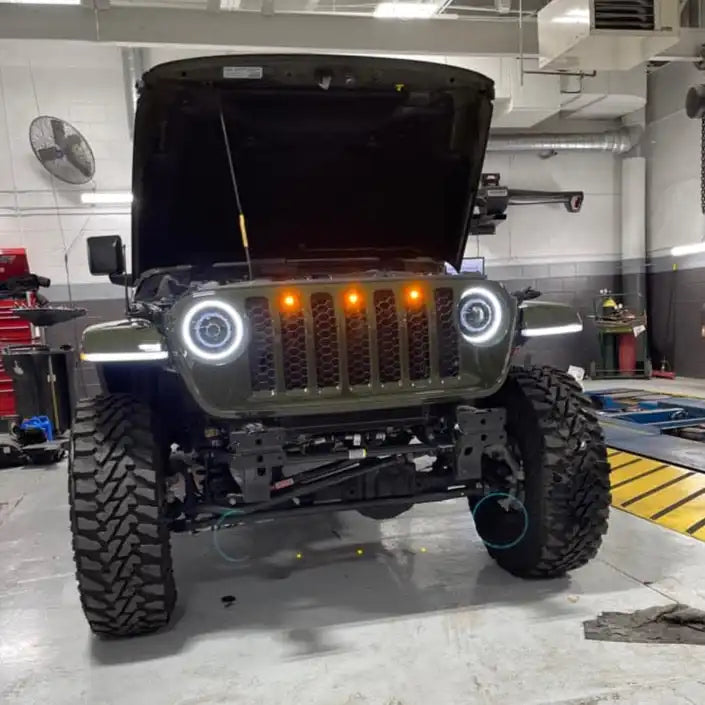 Front end of a Jeep Gladiator JT with amber Pre-Runner Style LED Grill Light Kit installed.