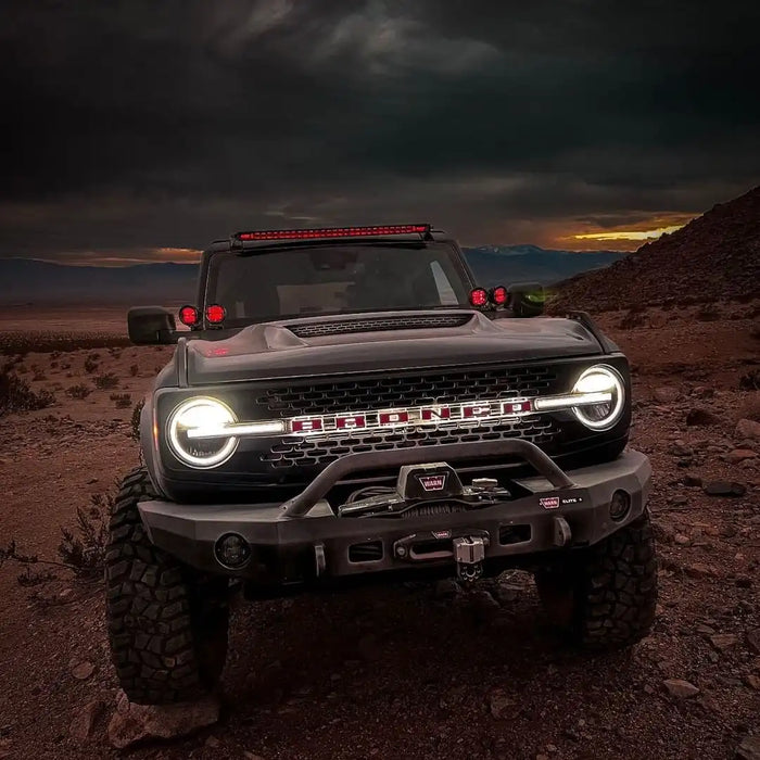 Front view of a Ford Bronco with Universal Illuminated LED Letter Badges installed.
