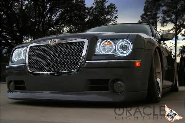 Front end of a Chrysler 300C with white LED headlight halo rings installed.