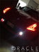 Front end of a Nissan 370Z with red LED headlight halo rings installed.