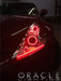 Close-up on a Nissan 370Z headlight with red LED halo rings installed.