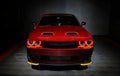 Front view of a red Dodge Challenger with red LED headlight halo rings installed.