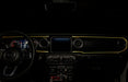 The dashboard of a Jeep with ColorSHIFT Fiber Optic LED Interior Kit installed, glowing yellow.