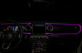 The dashboard of a Jeep with ColorSHIFT Fiber Optic LED Interior Kit installed, glowing pink.