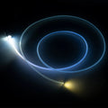 A fiber optic cable attached to a light head, glowing white.
