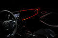 The dashboard of a car with ColorSHIFT Fiber Optic LED Interior Kit installed, glowing red.