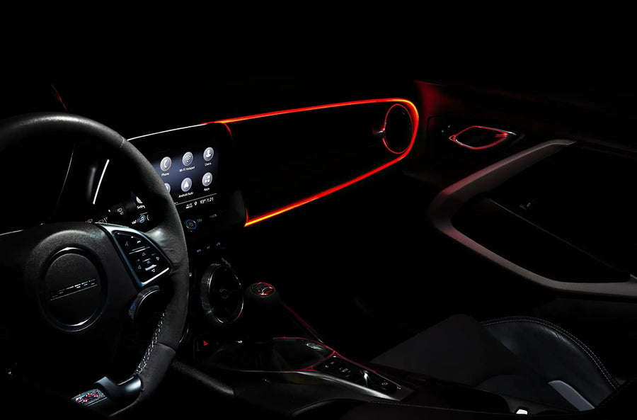 The dashboard of a car with ColorSHIFT Fiber Optic LED Interior Kit installed, glowing red.