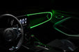 The dashboard of a car with ColorSHIFT Fiber Optic LED Interior Kit installed, glowing green.