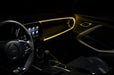 The dashboard of a car with ColorSHIFT Fiber Optic LED Interior Kit installed, glowing yellow.