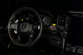 Drivers side seat of a RAM TRX with yellow LED ambient lighting.