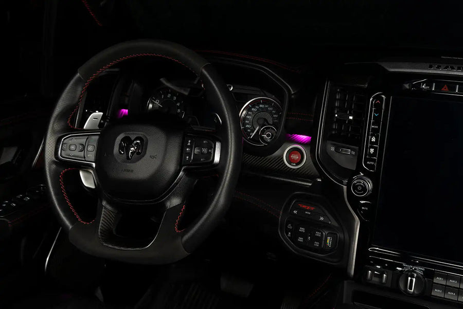 Drivers side seat of a RAM TRX with pink LED ambient lighting.