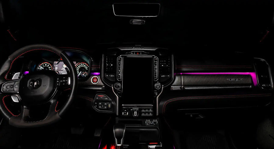 View of a RAM TRX dashboard from the backseat with pink LED ambient lighting kit.