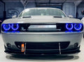 Front end of a Dodge Challenger with blue halo headlights.