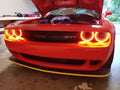 Red Dodge Challenger with red halo headlights.