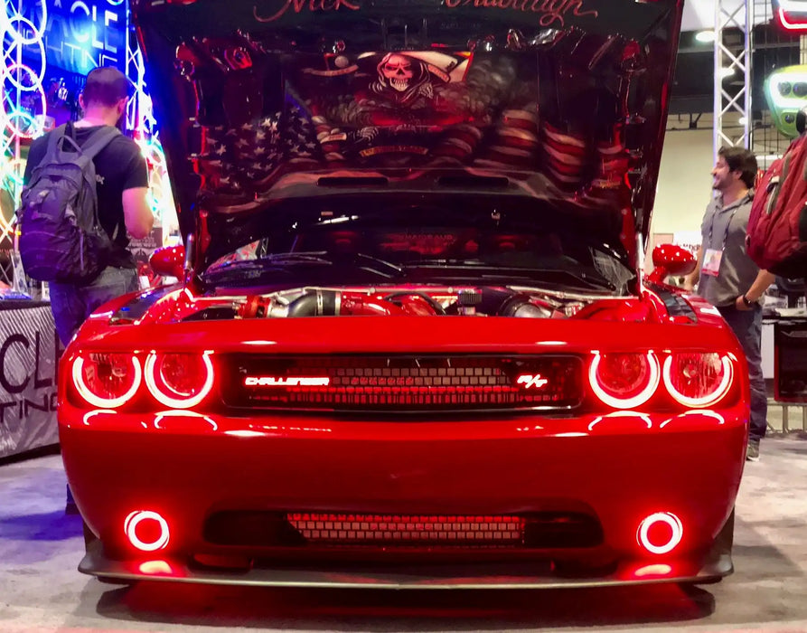 Red challenger in showroom with red headlight and fog light halos