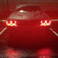 Dodge Challenger with red halo headlights.