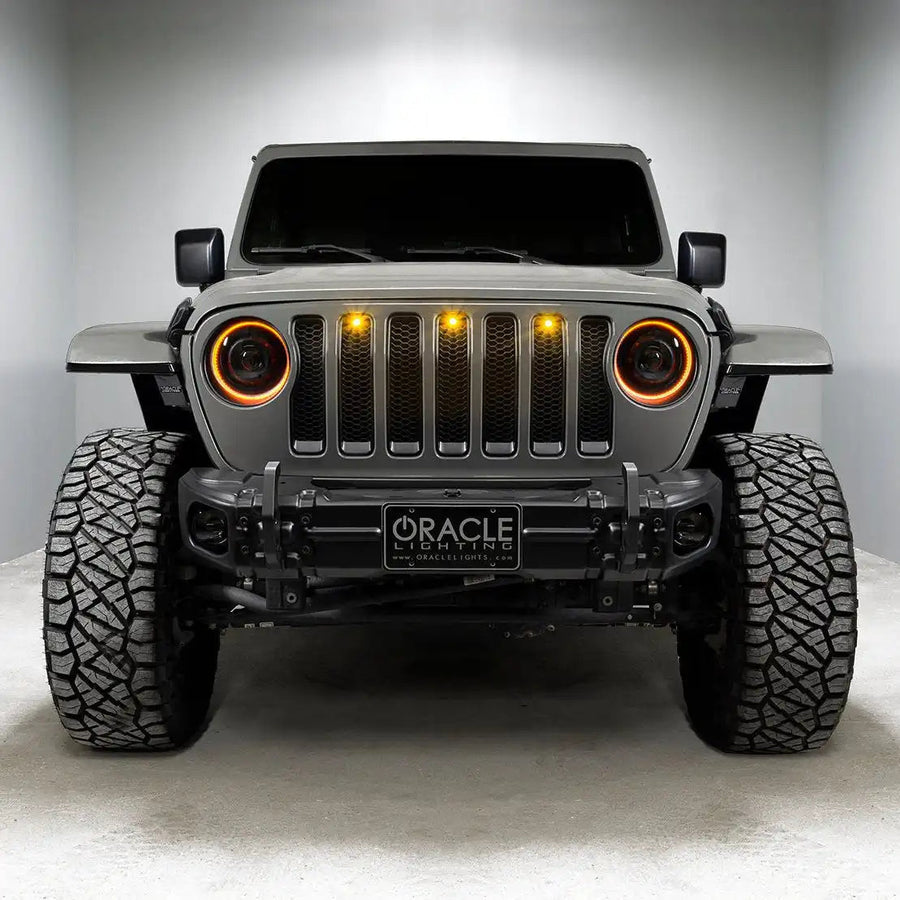 Front end of a Jeep with Oculus Headlights installed, with amber LED halos.