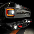 Close-up on the rear end of a Jeep Gladiator with reverse lights on.