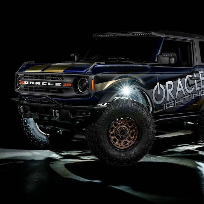 Ford Bronco with white rock lights installed and turned on.