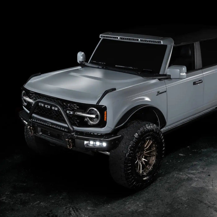 Three quarters view of grey Ford Bronco with Triple LED Fog Lights turned on.