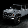 Three quarters view of grey Ford Bronco with Triple LED Fog Lights turned on.