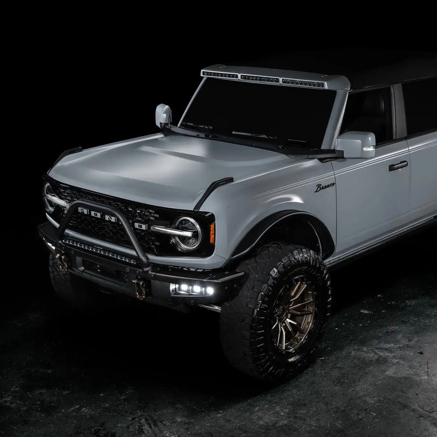 Three quarters view of grey Ford Bronco with Triple LED Fog Lights turned on.