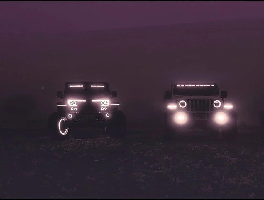 Two Jeeps side by side with multiple LED lighting products installed.