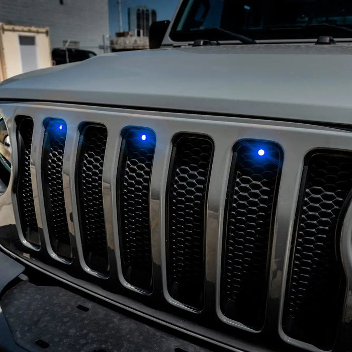 Close-up on the front end of a Jeep Wrangler with blue LED Grill Light Kit.